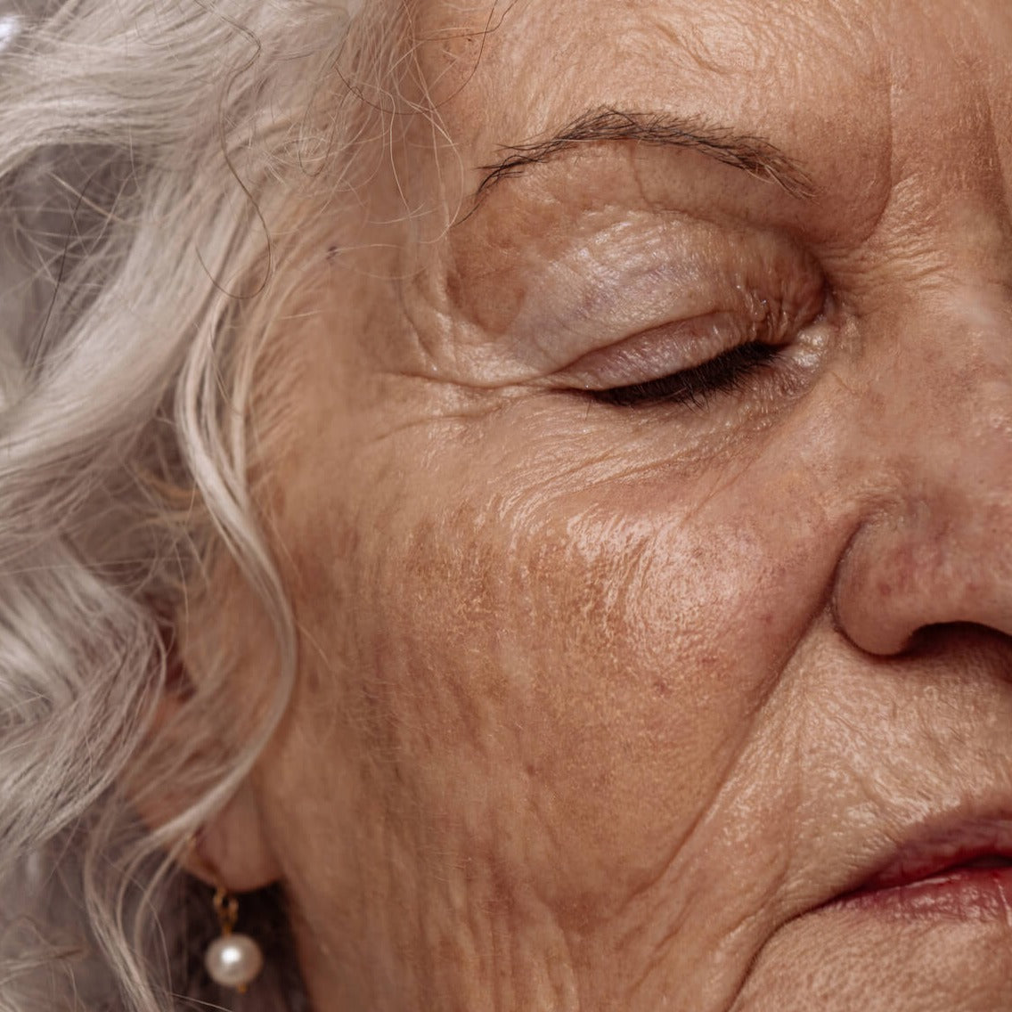 Close up of mature woman's skin that looks moisturized and glowy.