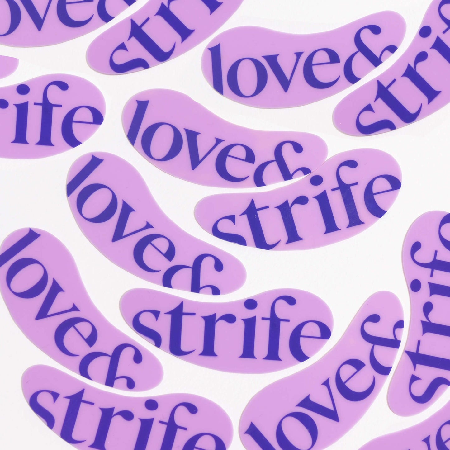 Several silicone eye patches featuring the love&strife logo.