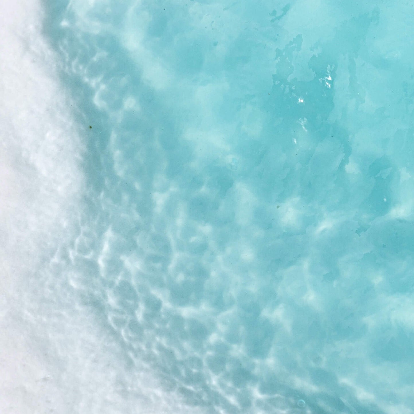 Close-up of a jelly, blue skincare mask with visible sea-like texture.